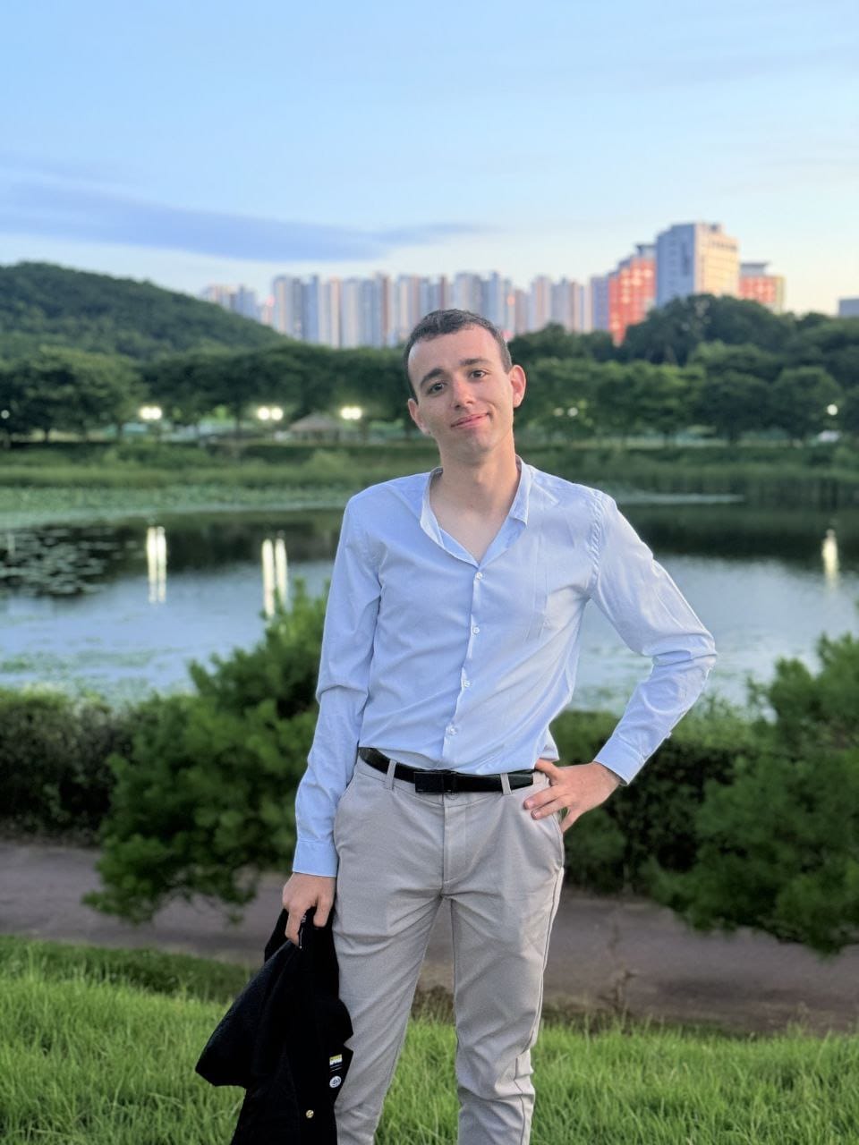 Roy Orbach standing beside a lake in Hong Kong
